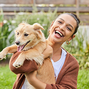 4-adoptpet-adobestock_499053599_300x300 Person holding dog in outdoor setting