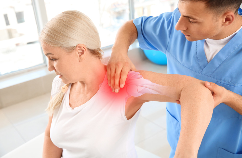 Healthcare professional examining shoulder pain